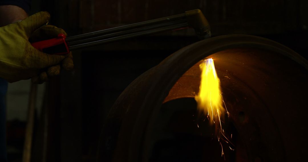 Worker Using Blow Torch for Metalwork in Dark Workshop - Free Images, Stock Photos and Pictures on Pikwizard.com