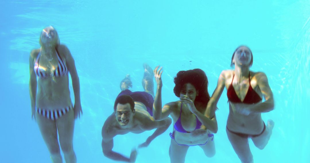 Group of Friends Swimming Underwater in Pool - Free Images, Stock Photos and Pictures on Pikwizard.com