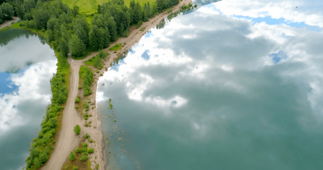 Transparent Clouds Reflecting Pristine Lake and Dirt Path