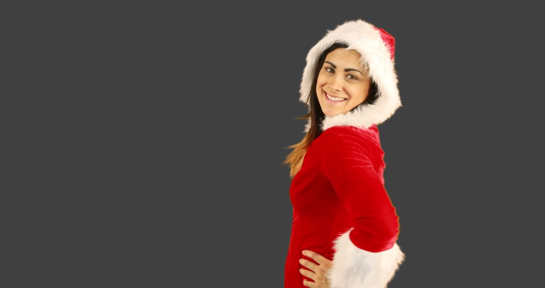 Smiling Woman Wearing Santa Hat Posing - Free Images, Stock Photos and Pictures on Pikwizard.com