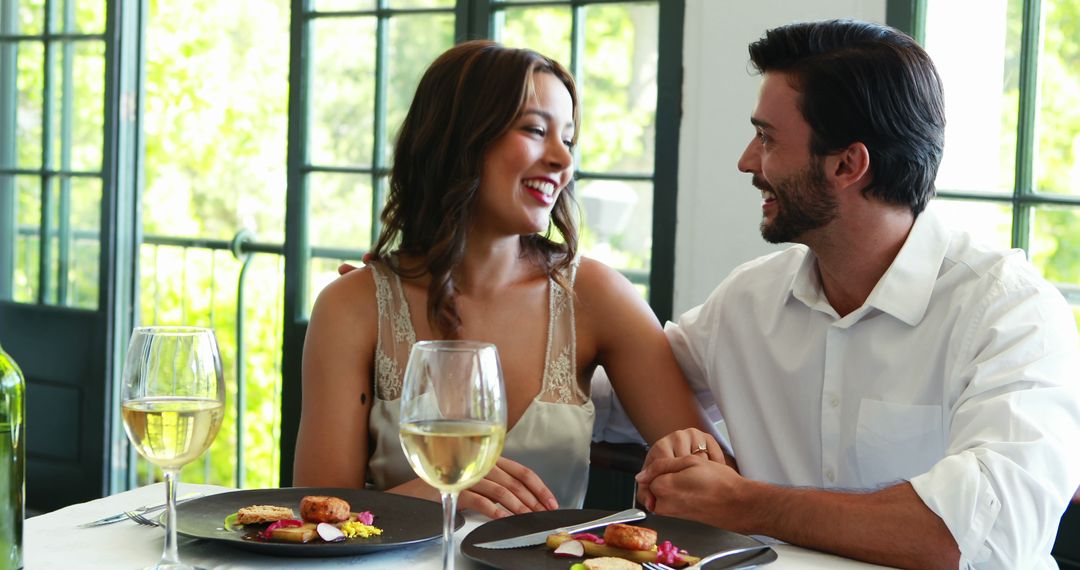 A young Caucasian couple enjoys a romantic meal together, with copy space - Free Images, Stock Photos and Pictures on Pikwizard.com