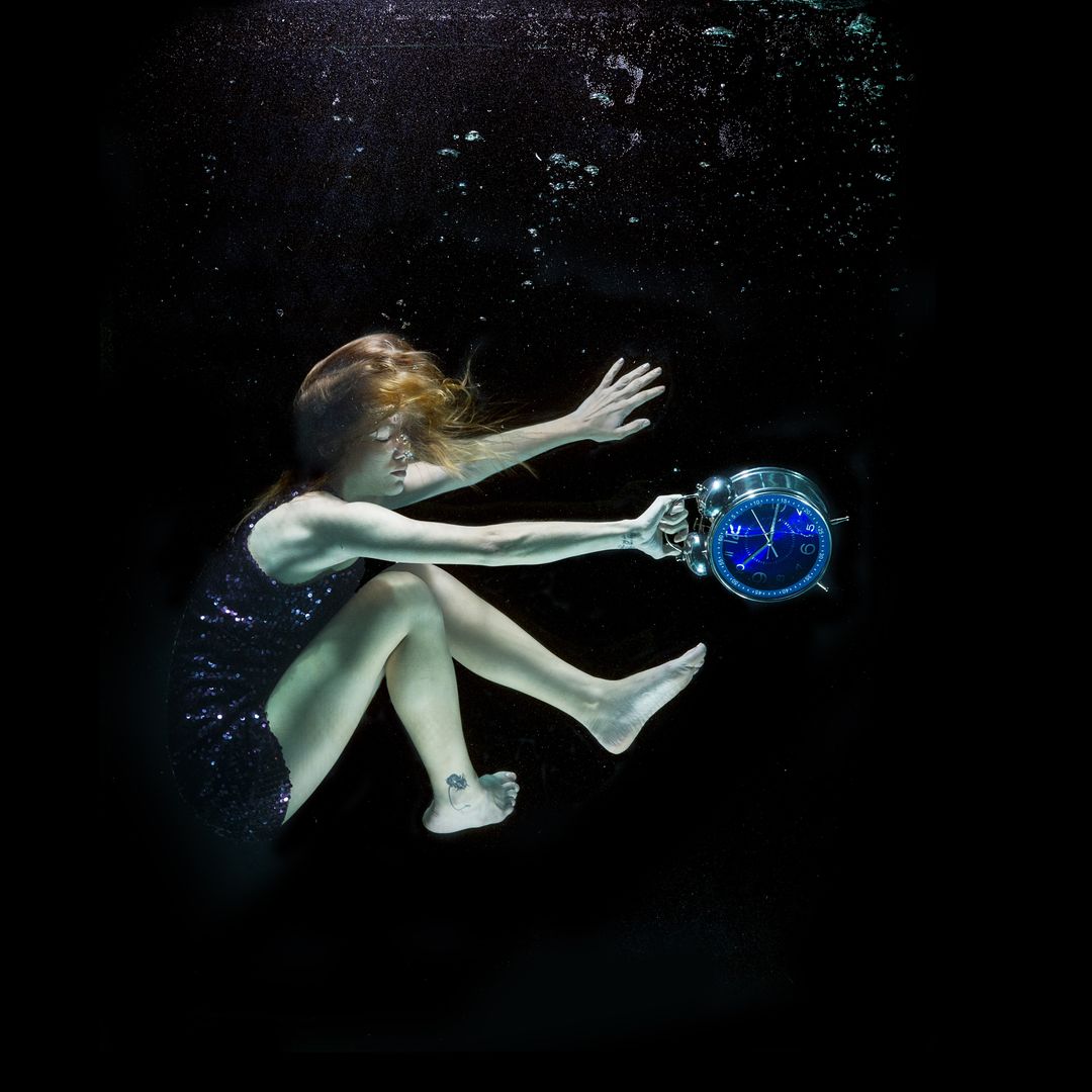 Surreal Underwater Scene with Woman and Clock - Free Images, Stock Photos and Pictures on Pikwizard.com