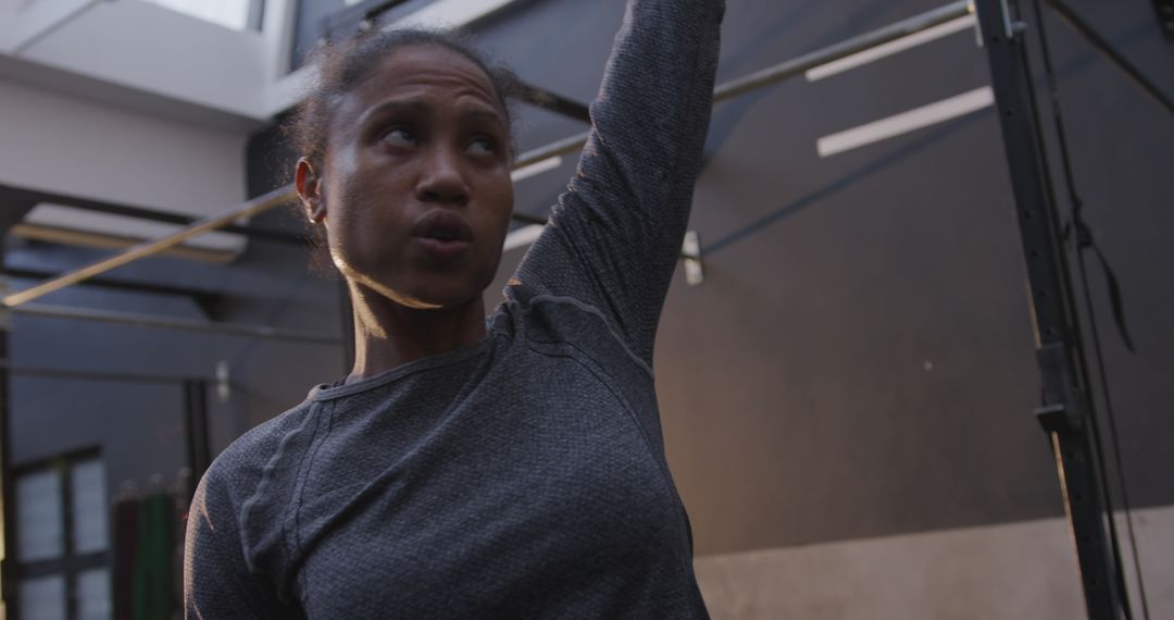 Focused Athlete Performing Kettlebell Overhead Exercise at Gym