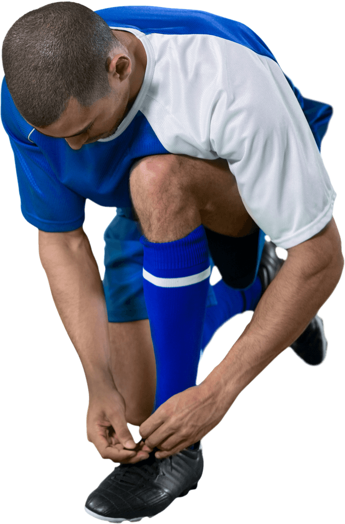 Athletic Soccer Player Tying Shoe Laces with Transparent Background