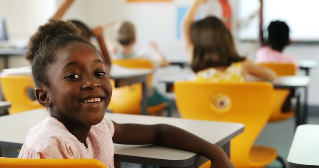 Smiling African American Schoolgirl in Classroom Focused on Learning - Free Images, Stock Photos and Pictures on Pikwizard.com