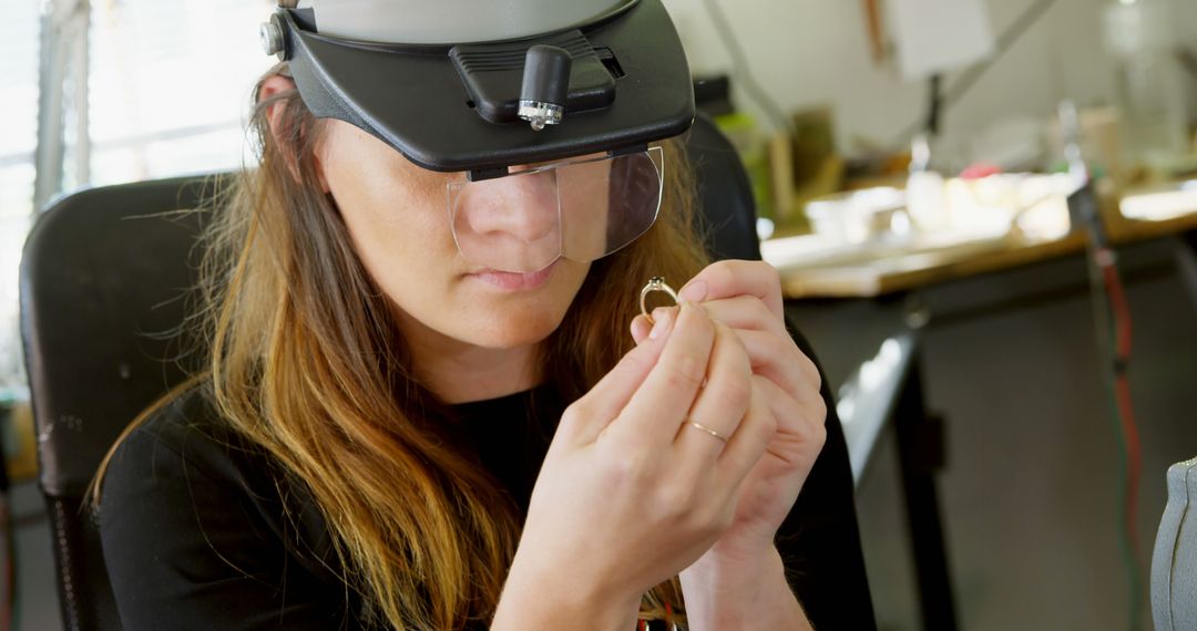 Jeweler Examining Ring Using Head-Mounted Magnifier in Workshop