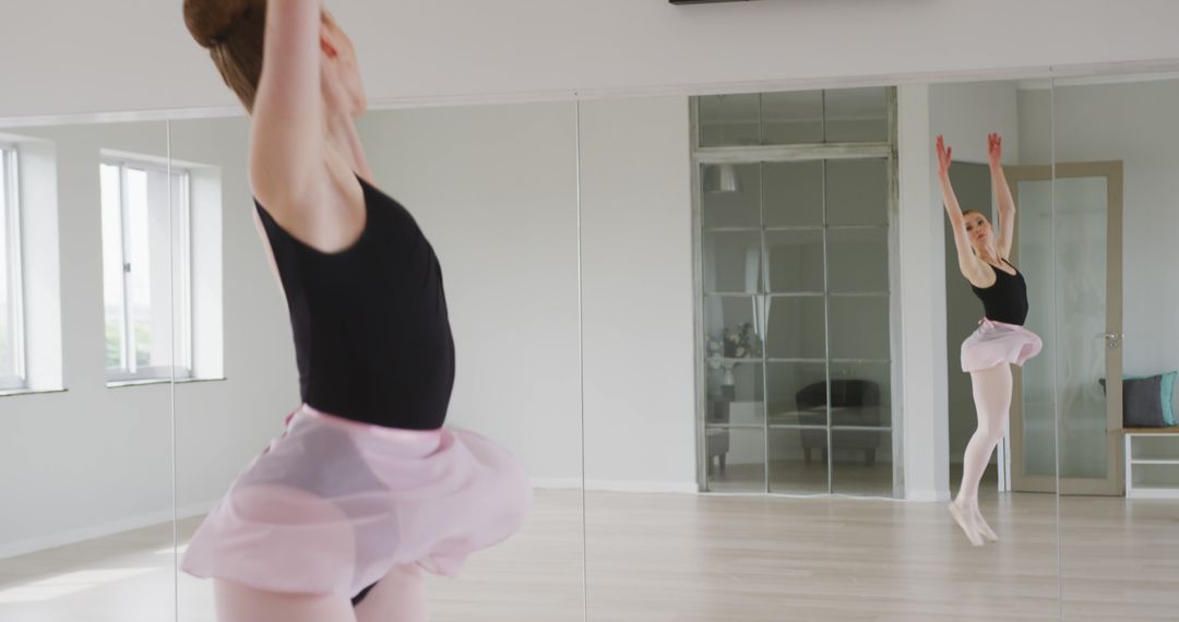 Caucasian Female Ballerina Practicing Dance Routine in Studio