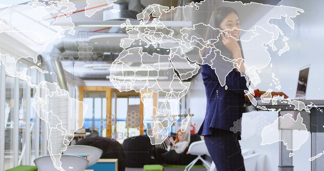 Talking Businesswoman Using Laptop and Phone at Standing Desk with World Map Overlay