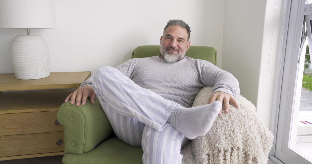 Senior Man Relaxing in Cozy Home Setting with Striped Lounge Pants