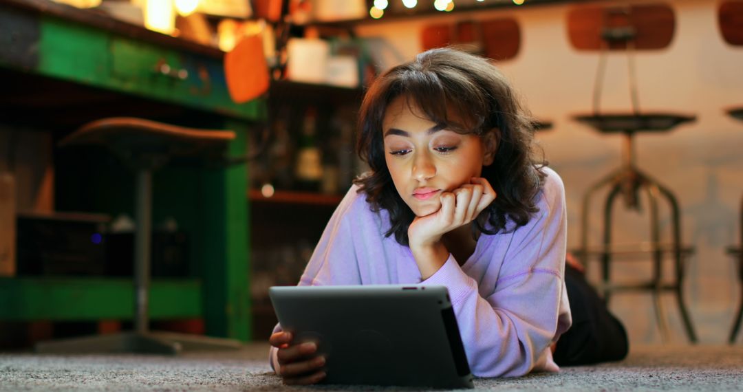 Young Woman Relaxing at Home Using Digital Tablet - Free Images, Stock Photos and Pictures on Pikwizard.com