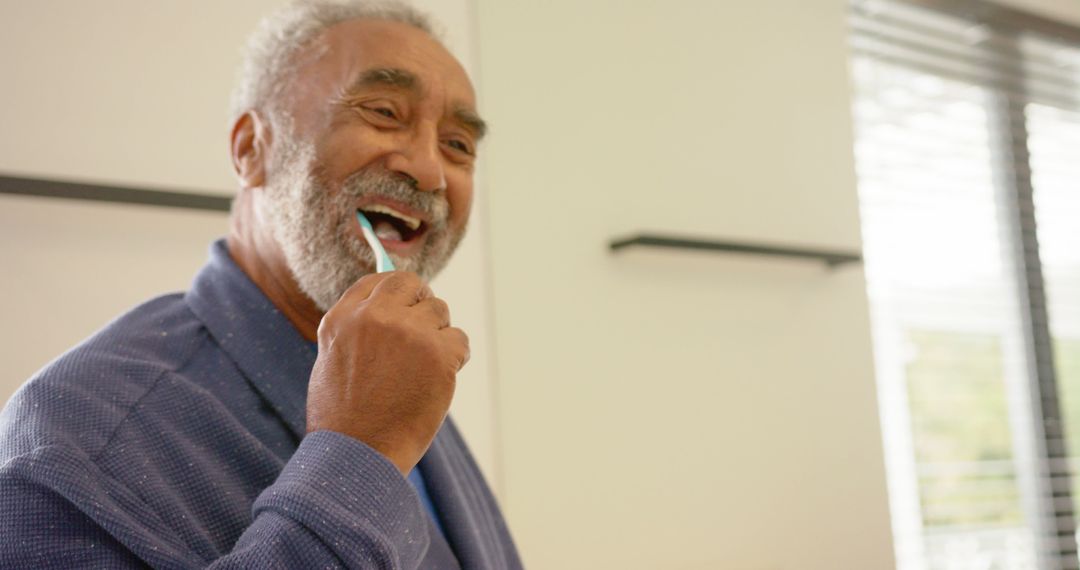 Senior African American Man Brushing Teeth in Bright Bathroom - Free Images, Stock Photos and Pictures on Pikwizard.com