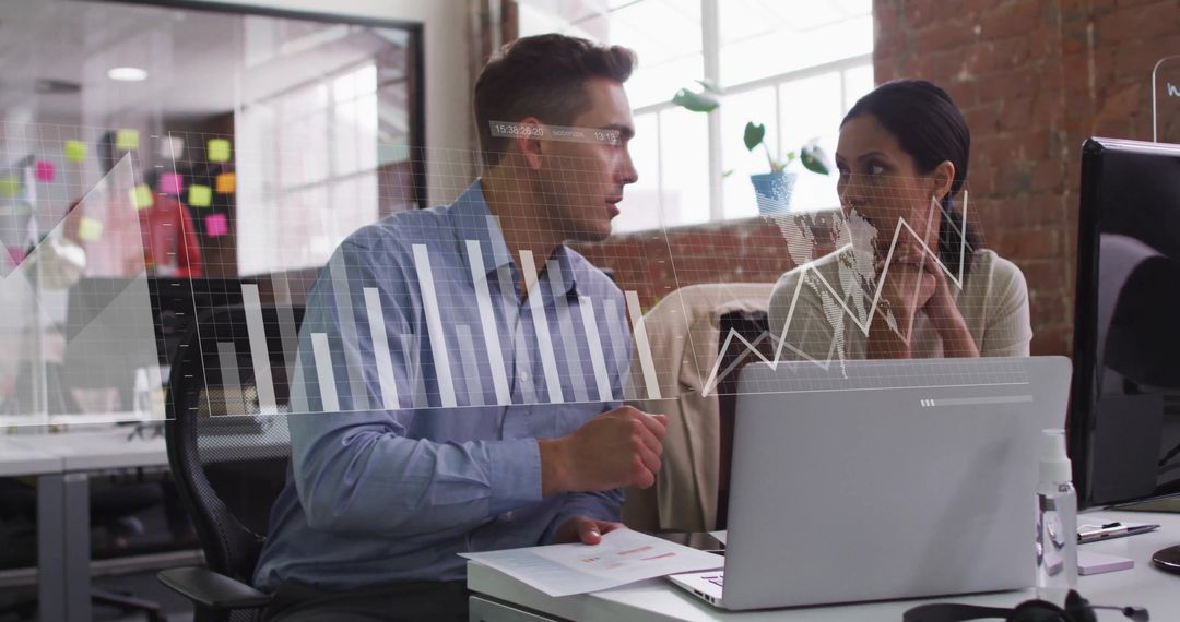 Colleagues Analyzing Data with Digital Interface in Office