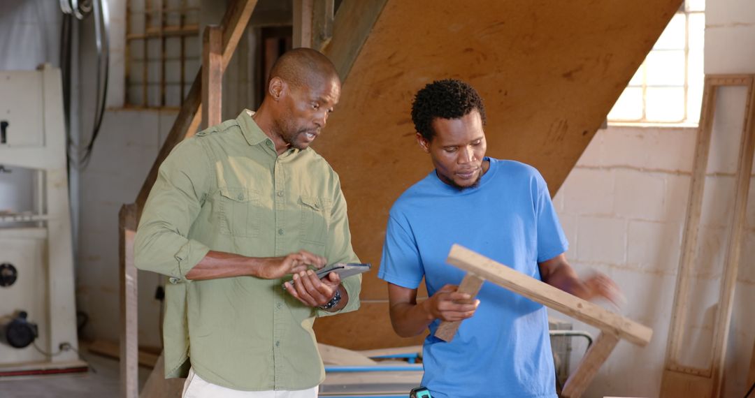 Male Colleagues Collaborating in Carpentry Workshop