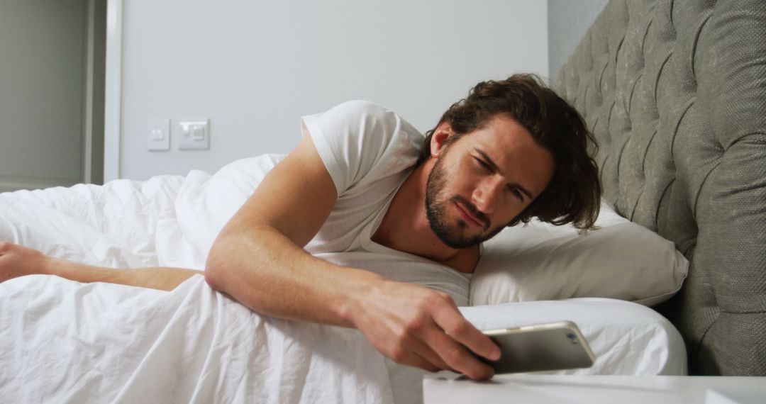 Man Waking Up and Using Smartphone in Bed - Free Images, Stock Photos and Pictures on Pikwizard.com