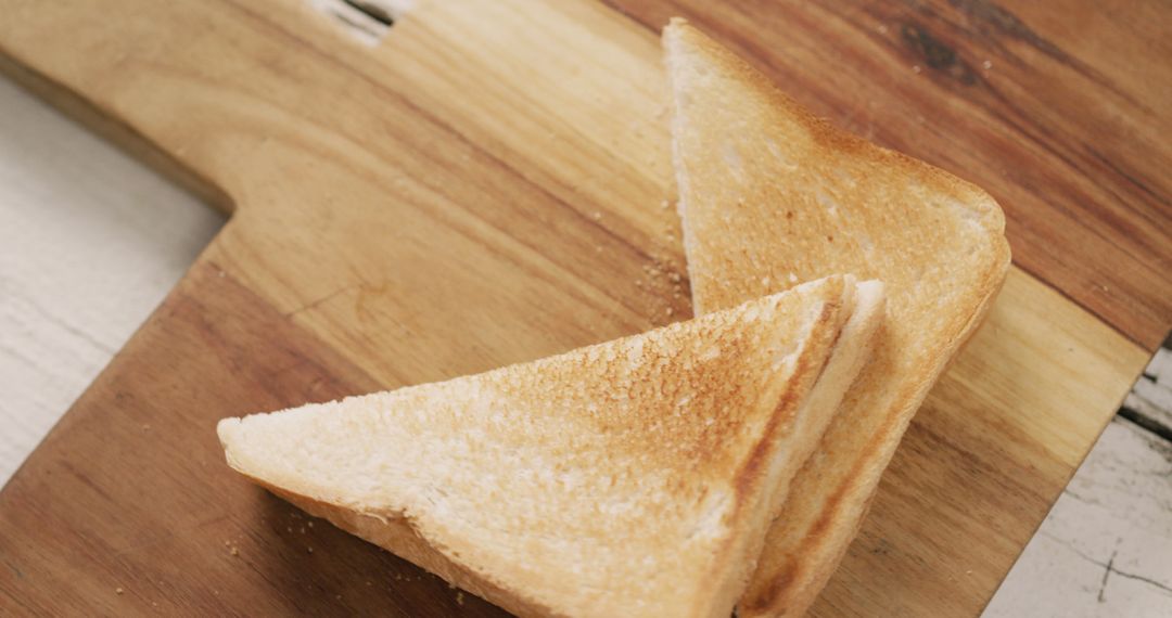 Image of slices of toasted cheese white bread sandwiches on wooden chopping board background - Free Images, Stock Photos and Pictures on Pikwizard.com