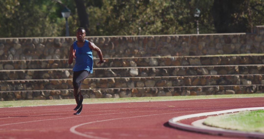 Athlete sprinting on outdoor track in bright daylight - Free Images, Stock Photos and Pictures on Pikwizard.com