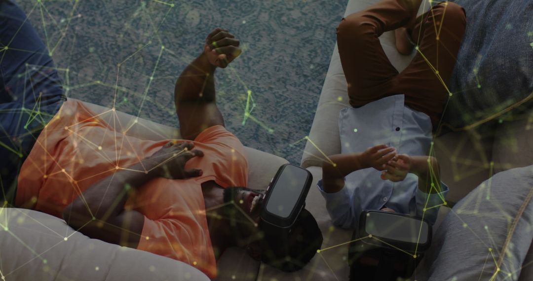 Father and Son Using VR Headsets Reflecting Digital Constellations