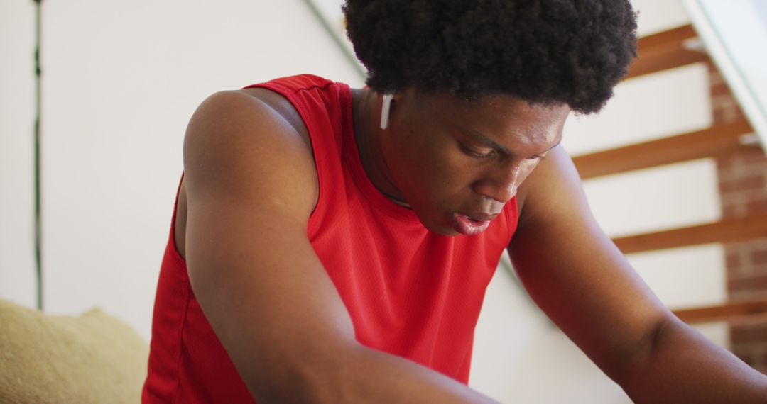 Fit Man in Red Athletic Gear Resting After Home Workout