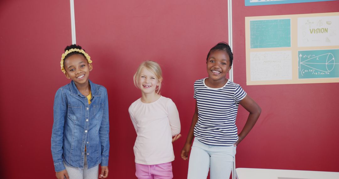 Three Diverse Young Friends Smiling in Classroom Setting