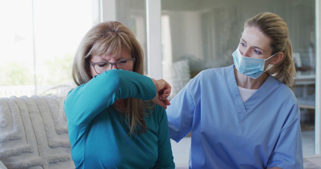 Health Care Worker Wearing Mask Assisting Woman Coughing into Elbow - Free Images, Stock Photos and Pictures on Pikwizard.com