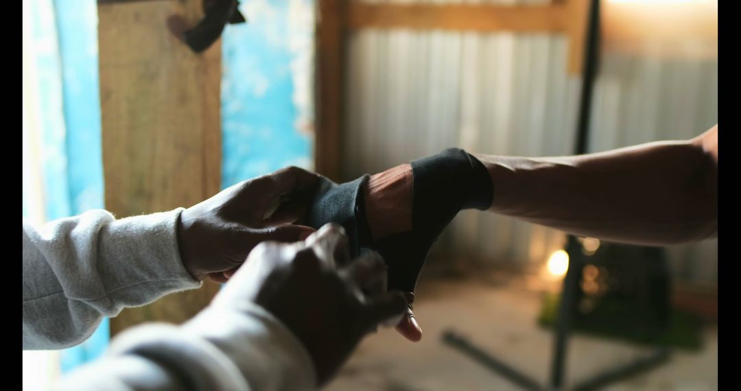 Male Boxing Trainer Wrapping Fighter's Hands for Gym Training