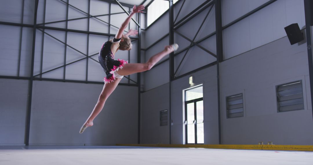 Young Gymnast Performing High Leap in Modern Gym - Free Images, Stock Photos and Pictures on Pikwizard.com