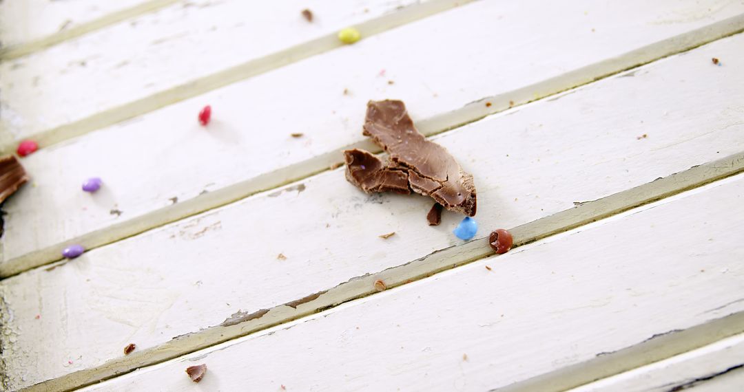 Close-Up of Scattered Chocolate Pieces and Candy on Wooden Surface - Free Images, Stock Photos and Pictures on Pikwizard.com