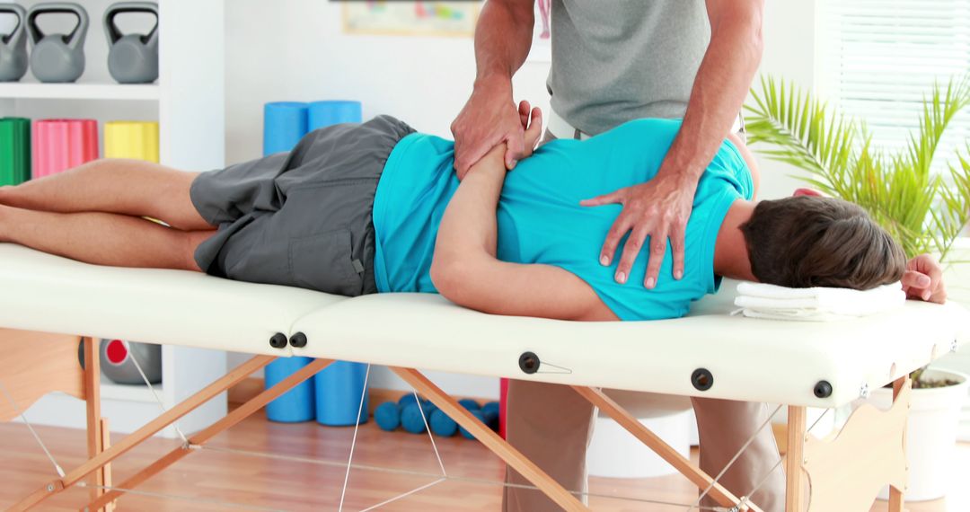 Physiotherapist Treating Patient with Manipulative Therapy on Treatment Table - Free Images, Stock Photos and Pictures on Pikwizard.com