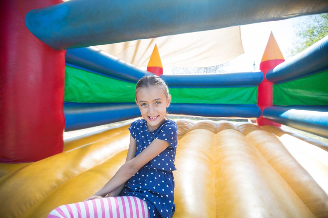 Smiling Girl Enjoying Time in Colorful Bounce House