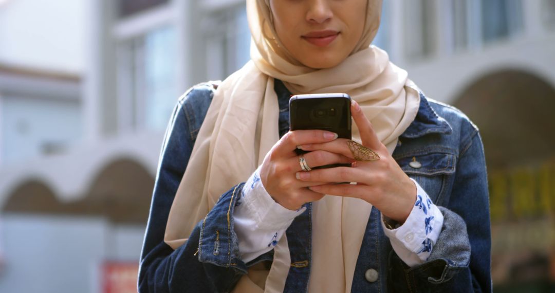 Young Women in Hijab Texting on Smartphone Outdoors - Free Images, Stock Photos and Pictures on Pikwizard.com