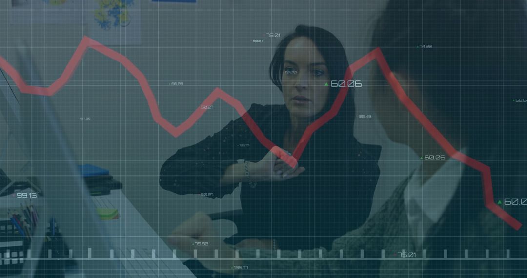 Two Businesswomen Analyzing Red Graph in Modern Office Heavily Focused