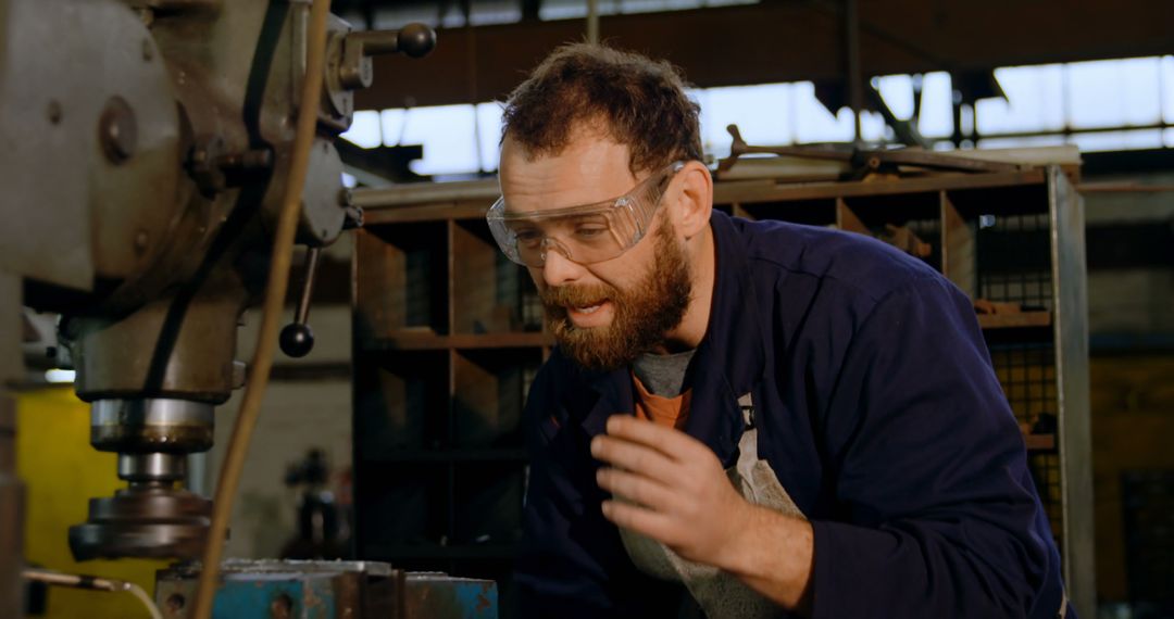 Factory Worker Operating Machinery Wearing Safety Goggles - Free Images, Stock Photos and Pictures on Pikwizard.com