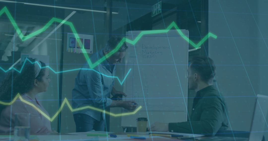 Presenter Pointing at Flip Chart While Team Brainstorming with Data Charts in Modern Office