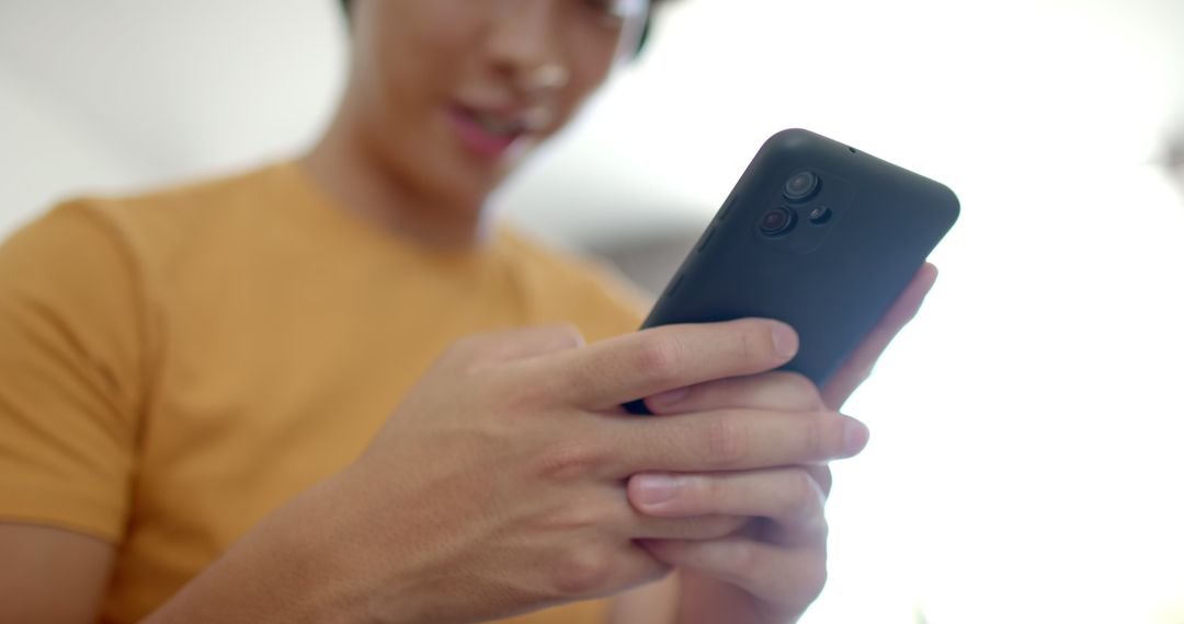 Young Adult Engaged with Smartphone Display