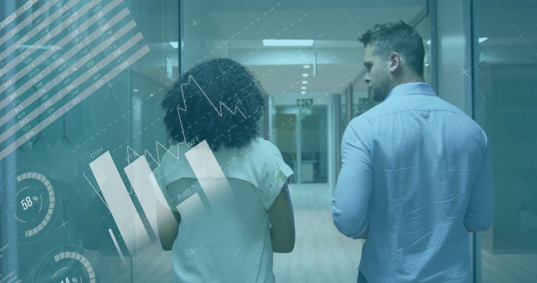 Business Colleagues Analyzing Data in Office Corridor