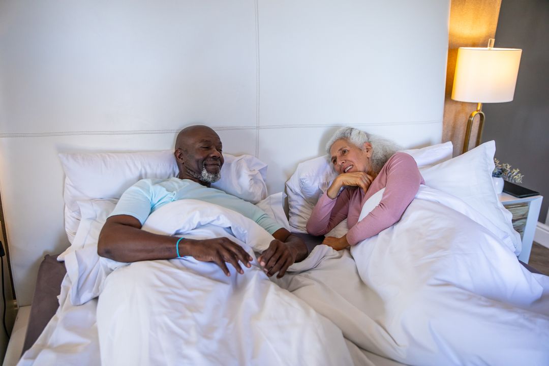 Senior Couple Relaxing in Bedroom with Cozy Atmosphere