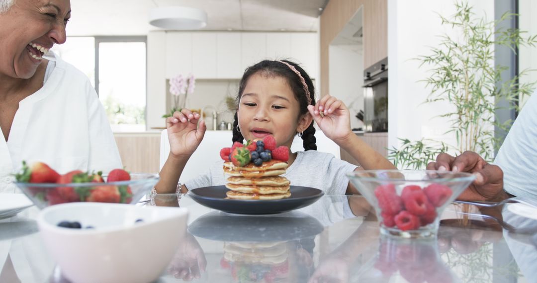 Cheerful Family Breakfast with Berries and Pancakes