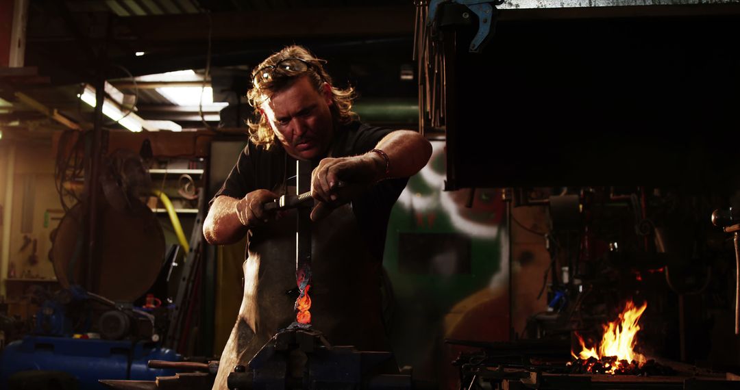 Focused Blacksmith Shaping Glowing Red Hot Metal - Free Images, Stock Photos and Pictures on Pikwizard.com