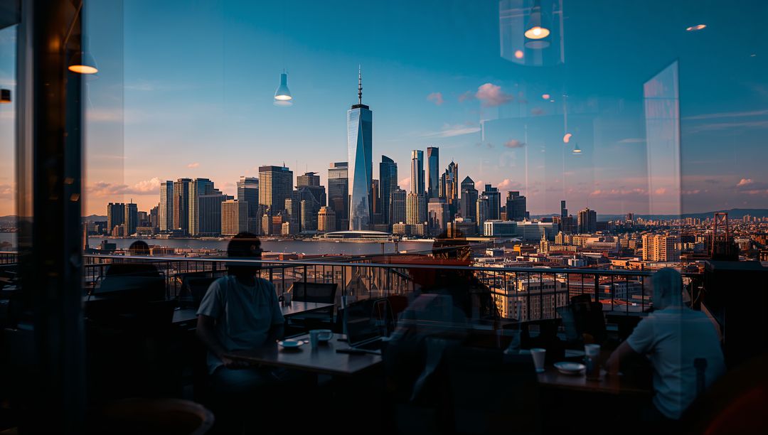 Rooftop diners enjoying Manhattan skyline with One World Trade Center at golden hour
