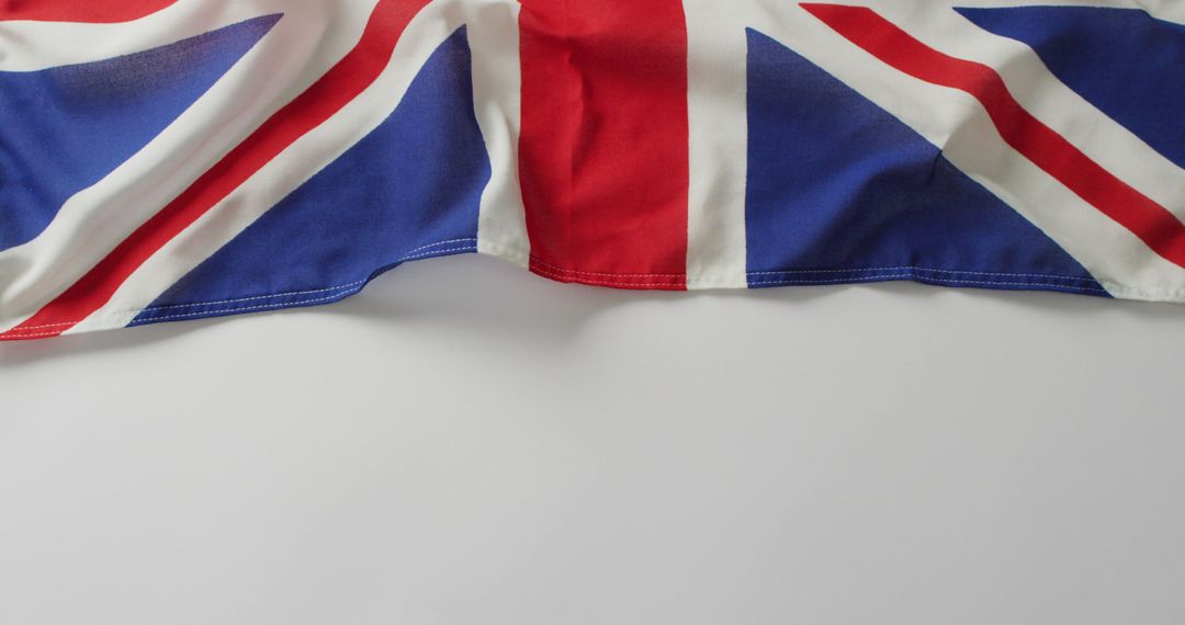 United Kingdom Flag Draped Over White Background - Free Images, Stock Photos and Pictures on Pikwizard.com