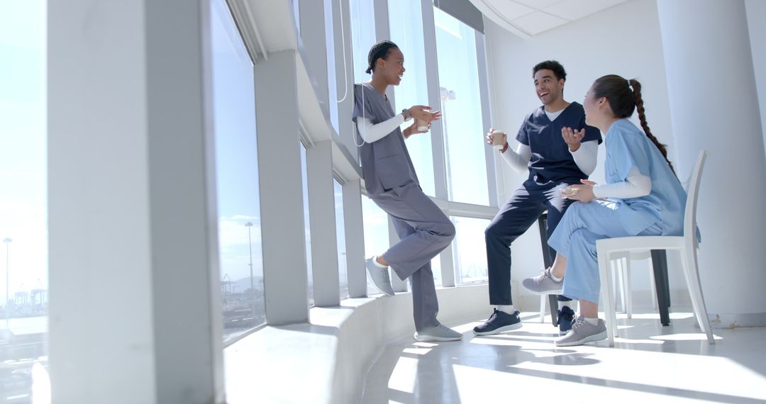 Diverse Healthcare Team Relaxing during Break at Hospital with Bright Views