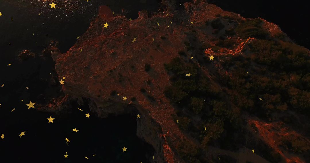 Celestial Stars Hovering Over Rocky Coastal Cliff at Night