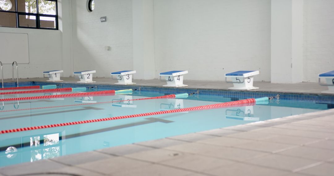 Empty Indoor Pool with Starting Blocks and Lane Dividers