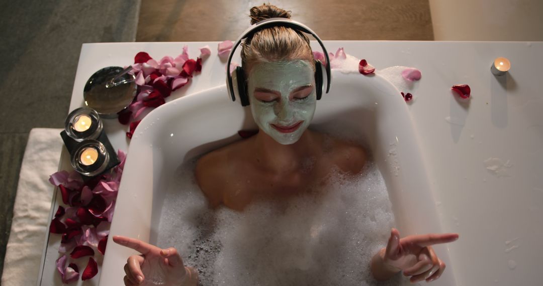 Young Woman Enjoying Relaxing Bubble Bath with Face Mask and headphones - Free Images, Stock Photos and Pictures on Pikwizard.com