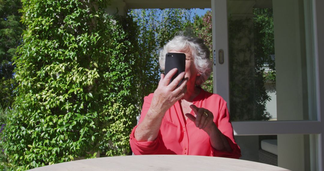 Elderly Woman Video Calling with Smartphone Outdoors - Free Images, Stock Photos and Pictures on Pikwizard.com