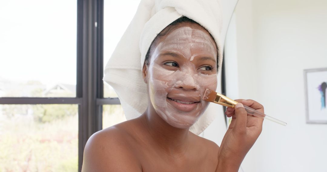 Young African American Woman Applying Facial Mask for Skincare - Free Images, Stock Photos and Pictures on Pikwizard.com