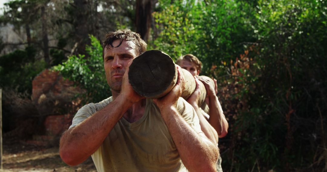 Fit Men Carrying Wooden Log During Outdoor Workout - Free Images, Stock Photos and Pictures on Pikwizard.com