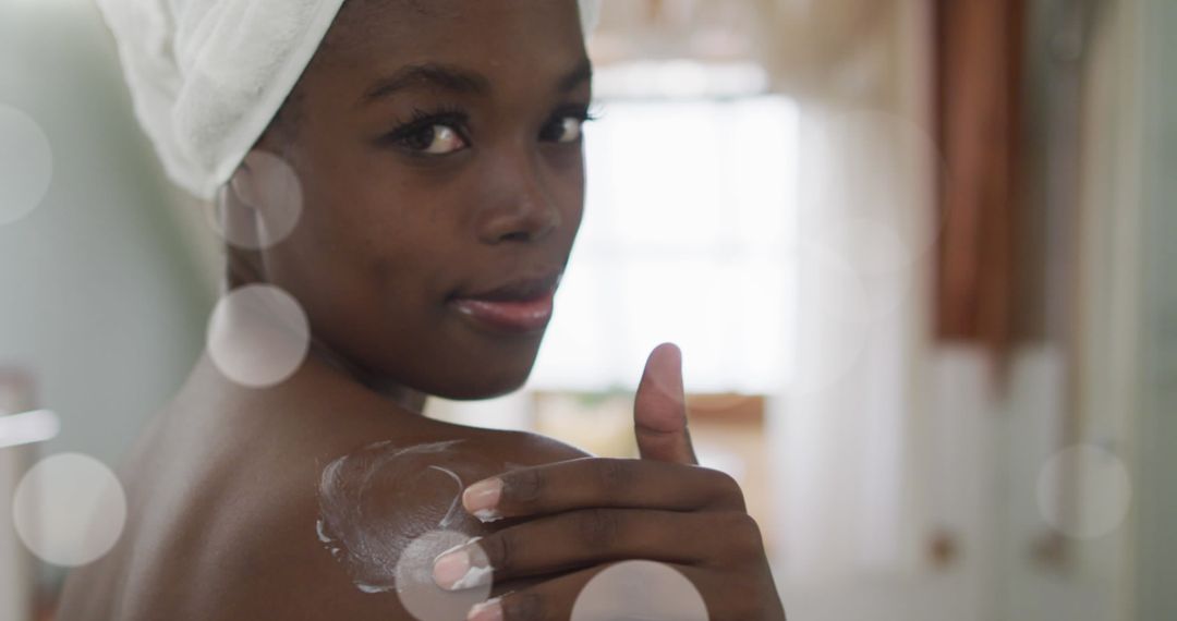 African American Woman Applying Skincare Cream over Light Spots - Free Images, Stock Photos and Pictures on Pikwizard.com