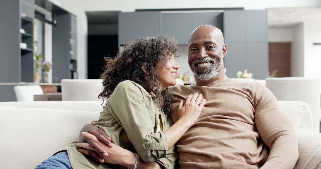 Happy Biracial Couple Relaxing on Couch at Home