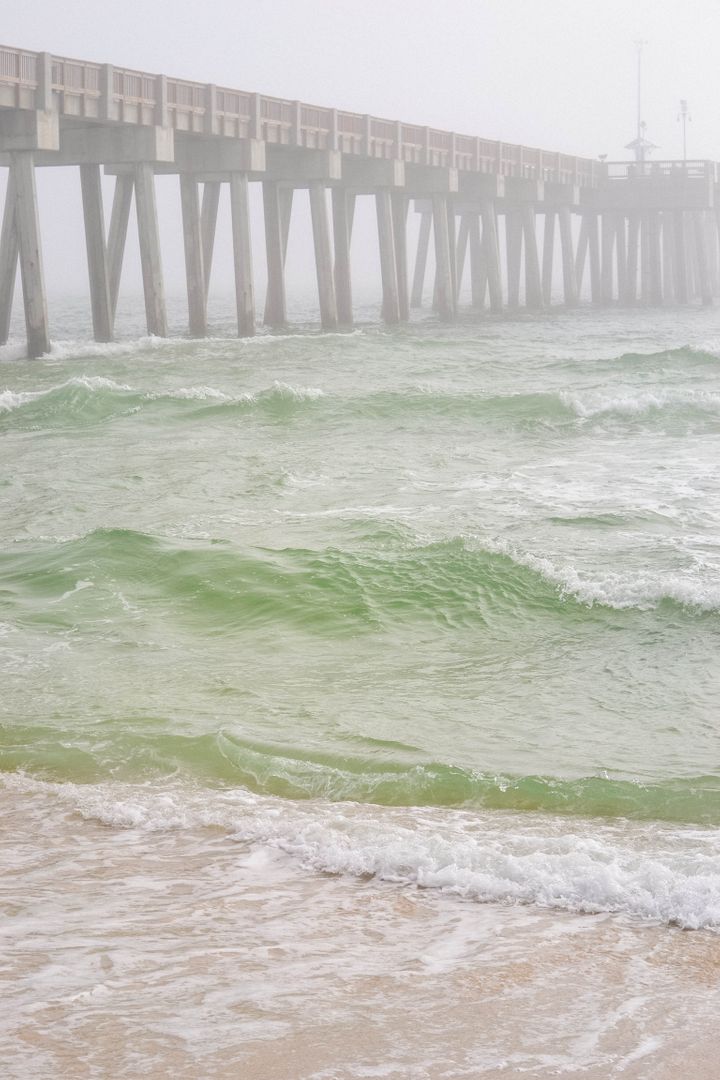 Serene Ocean Waves Under Rustic Pier on Misty Day - Free Images, Stock Photos and Pictures on Pikwizard.com